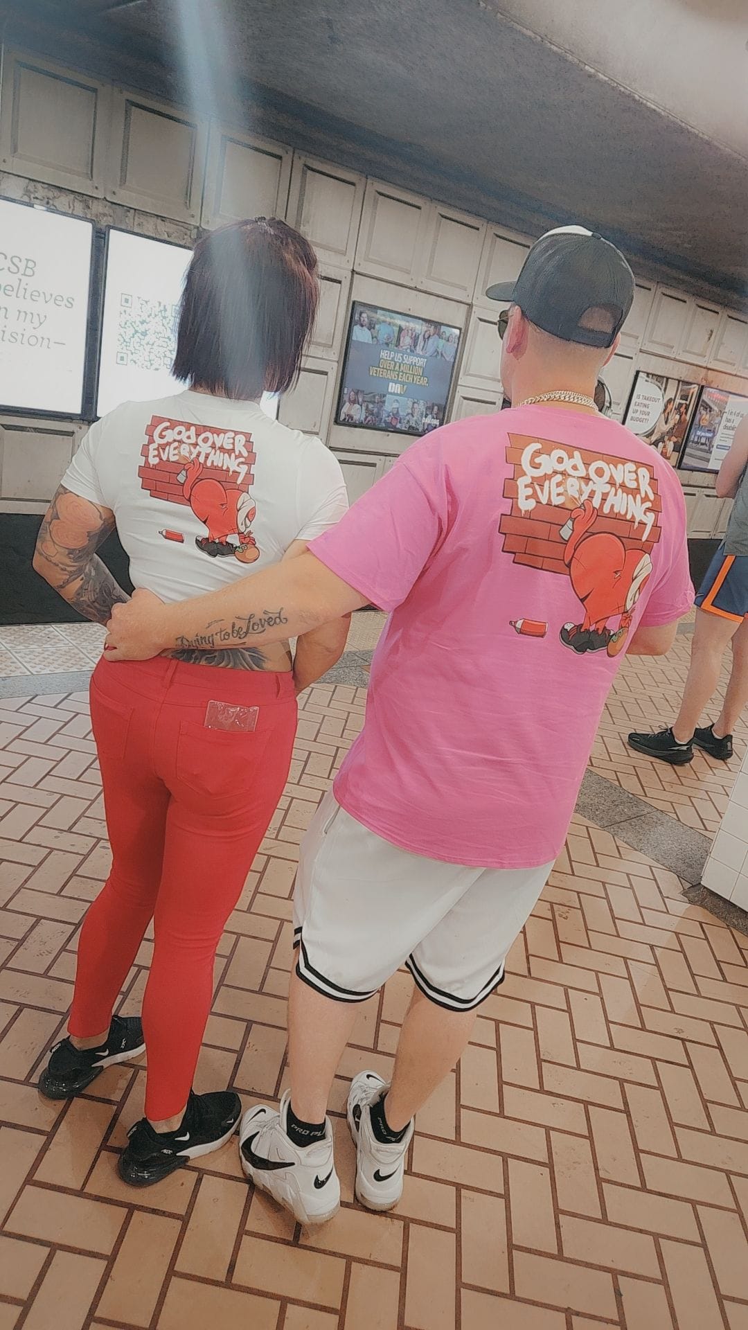 NVUS Hearts community members wearing God Over Everything shirts